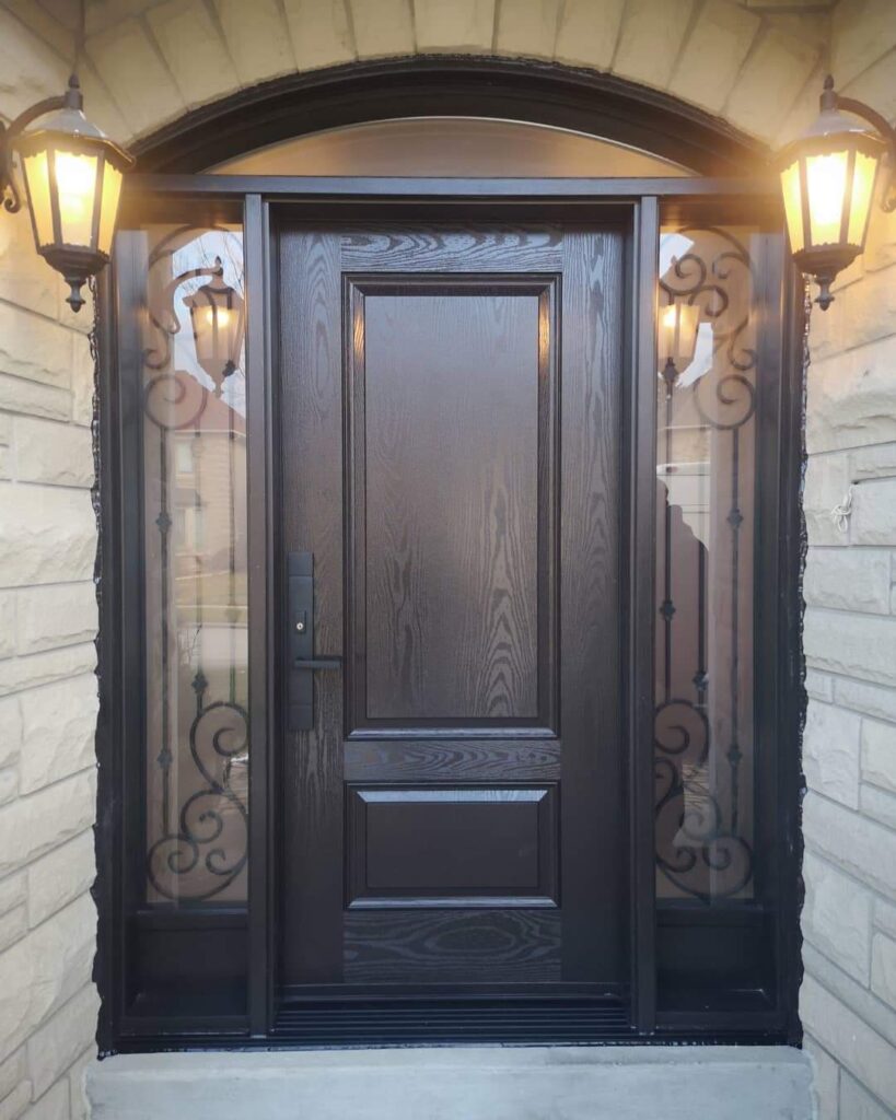 Newly installed dark woodgrain fiberglass entry door with decorative side panels on Winnipeg home