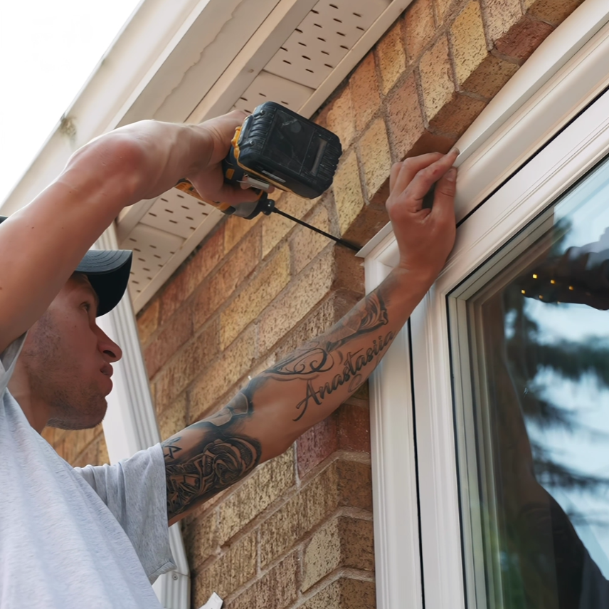 Door installation specialist measuring and fitting insulated door frame in Winnipeg home