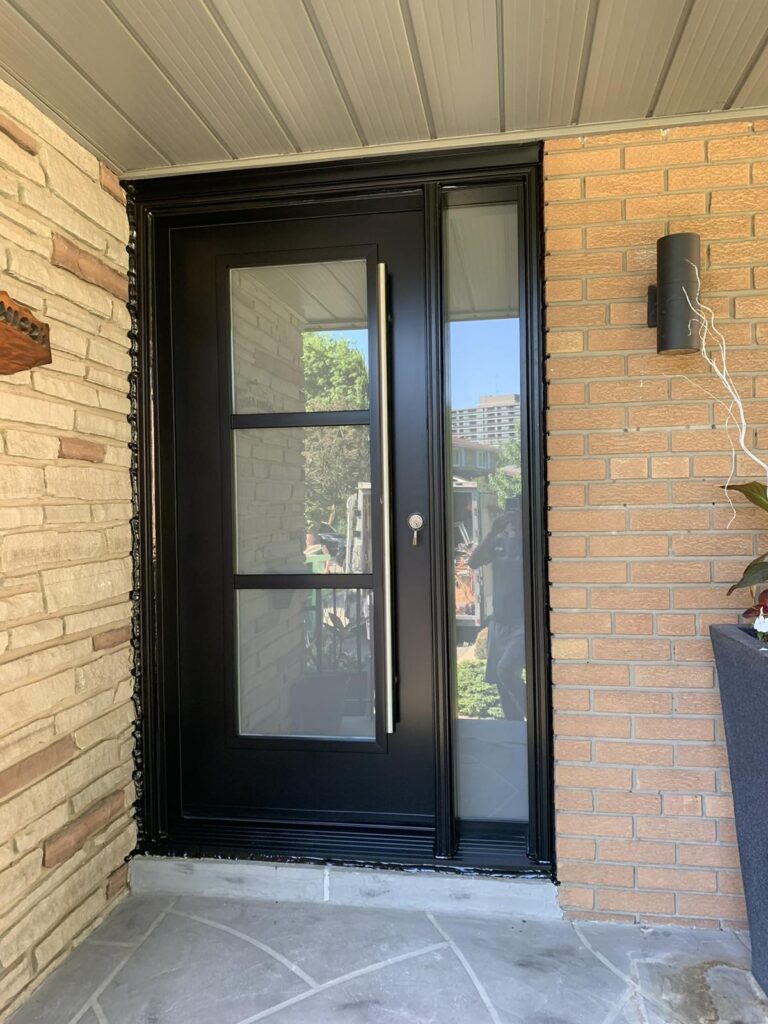 Door replacement service showing modern steel entry door with vertical glass design in Winnipeg