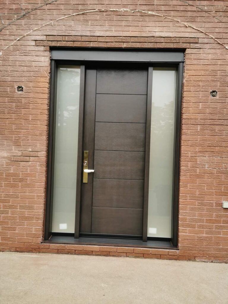 Dark brown fiberglass entry door with frosted double sidelites and gold lever handle installed on Winnipeg brick home