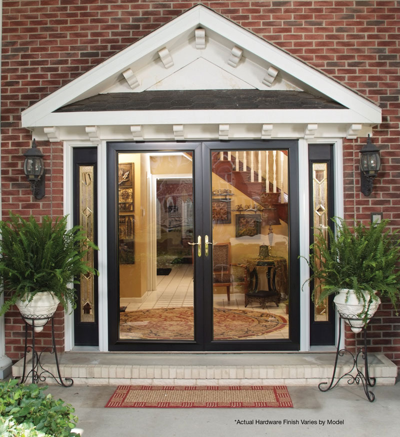 Elegant decorative glass double front entry doors installed on Winnipeg brick home with classic gable and side panels