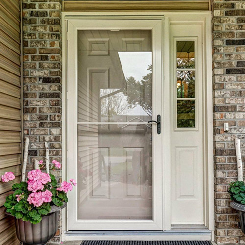 Front entry storm door with full-view glass and side window installed for enhanced security, insulation, and curb appeal